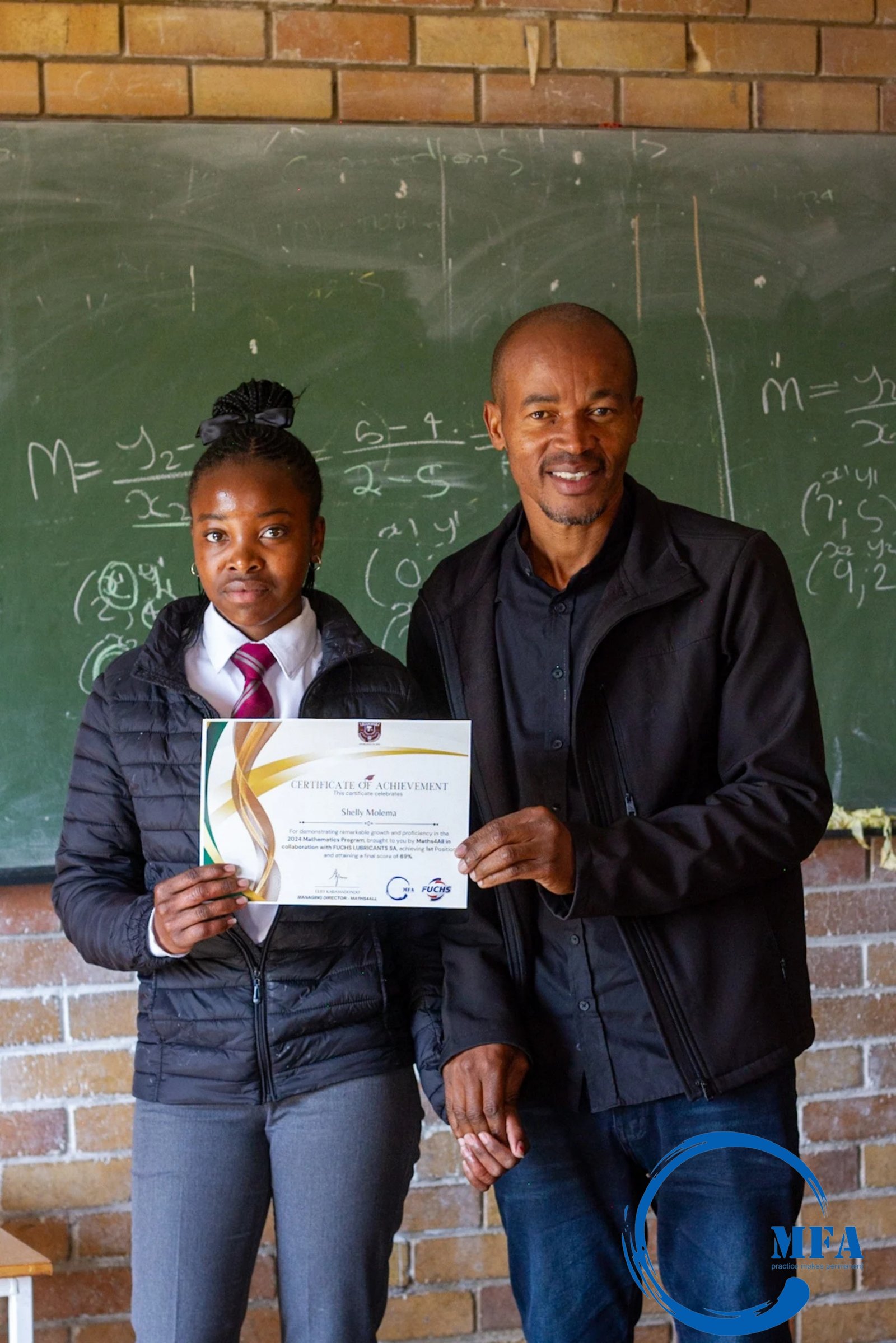 Student receiving a certificate with tutor